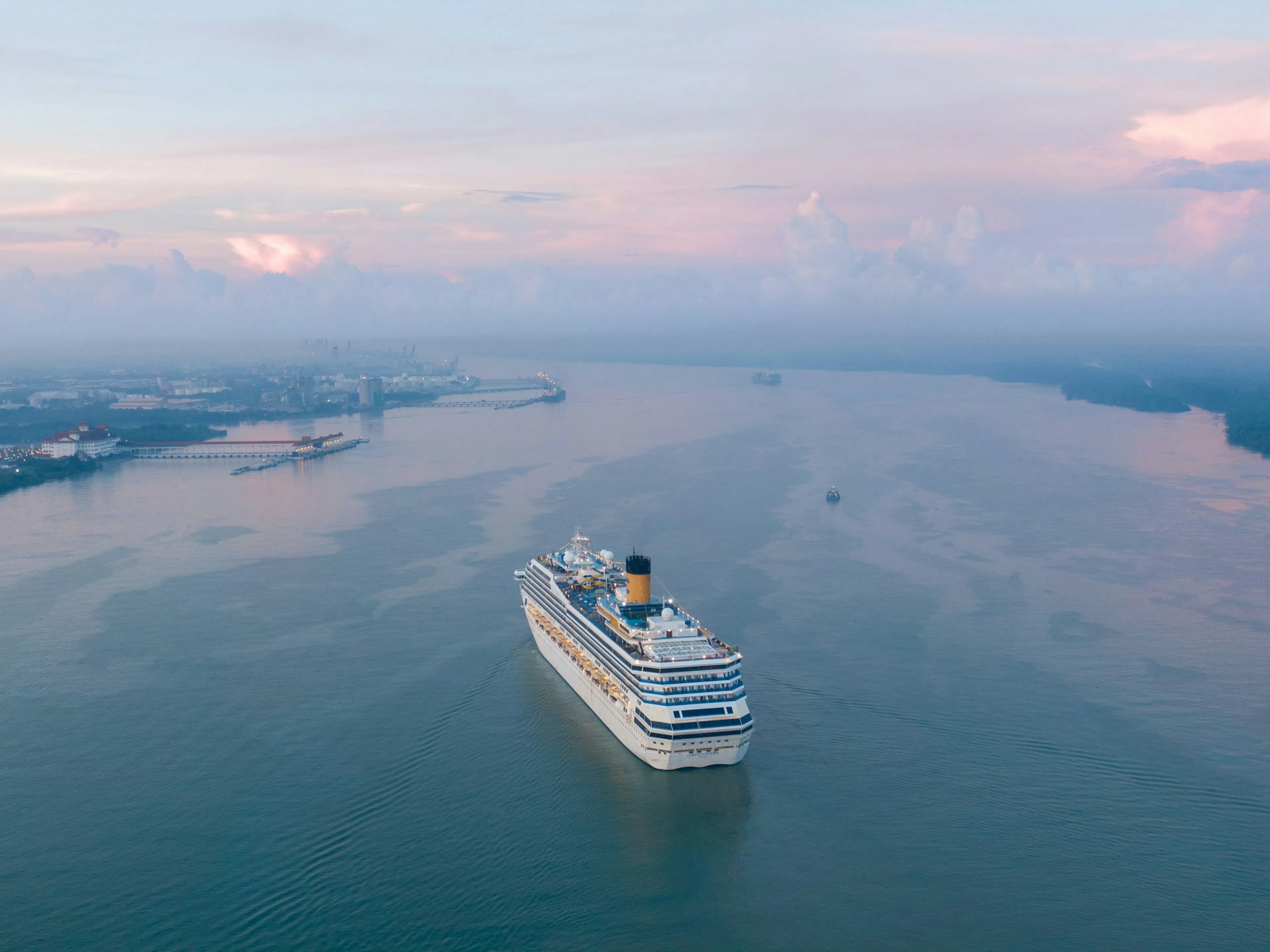 Large cruise ship sailing under clear blue sky