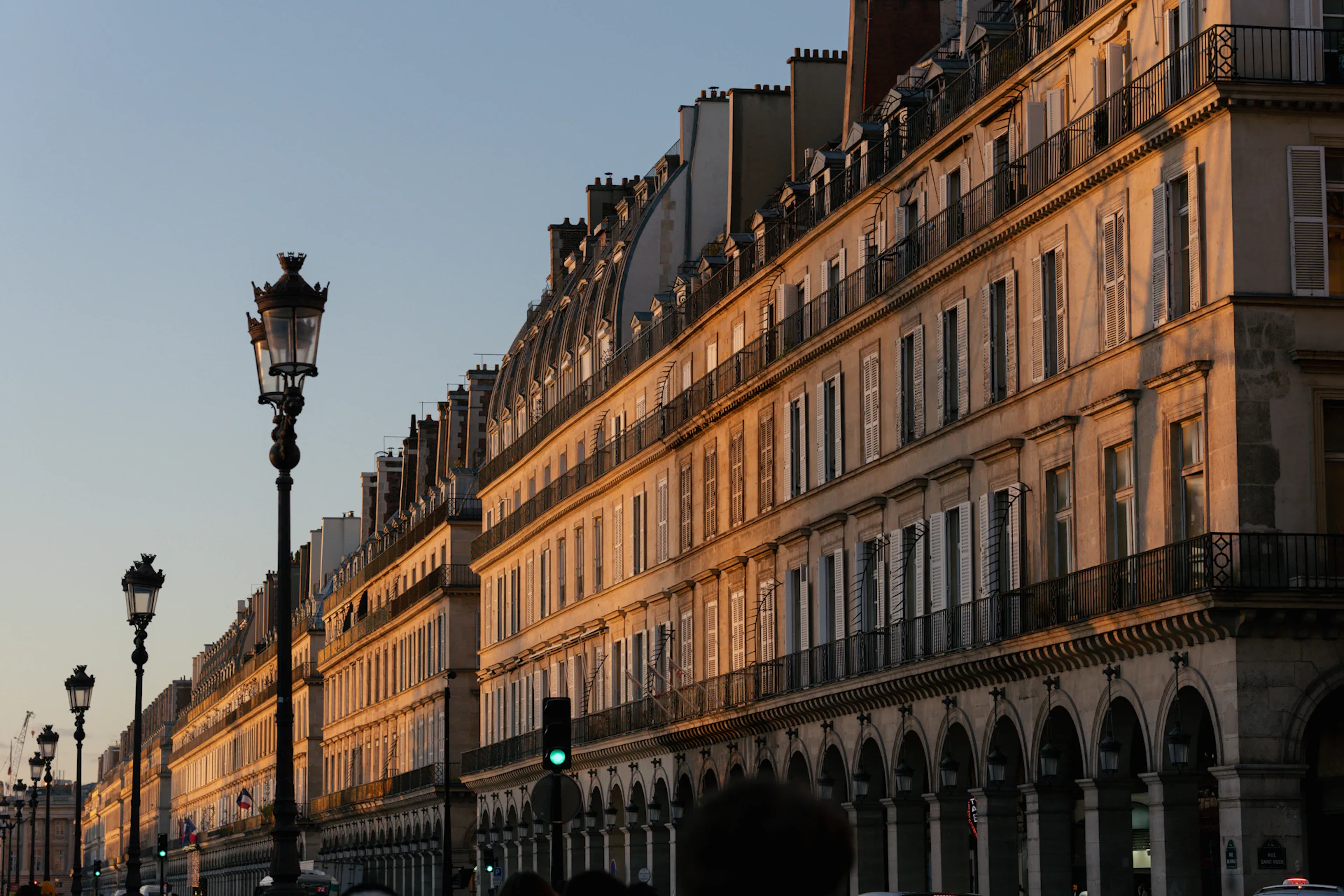 Parisian buildings illuminated by golden hour sunlight