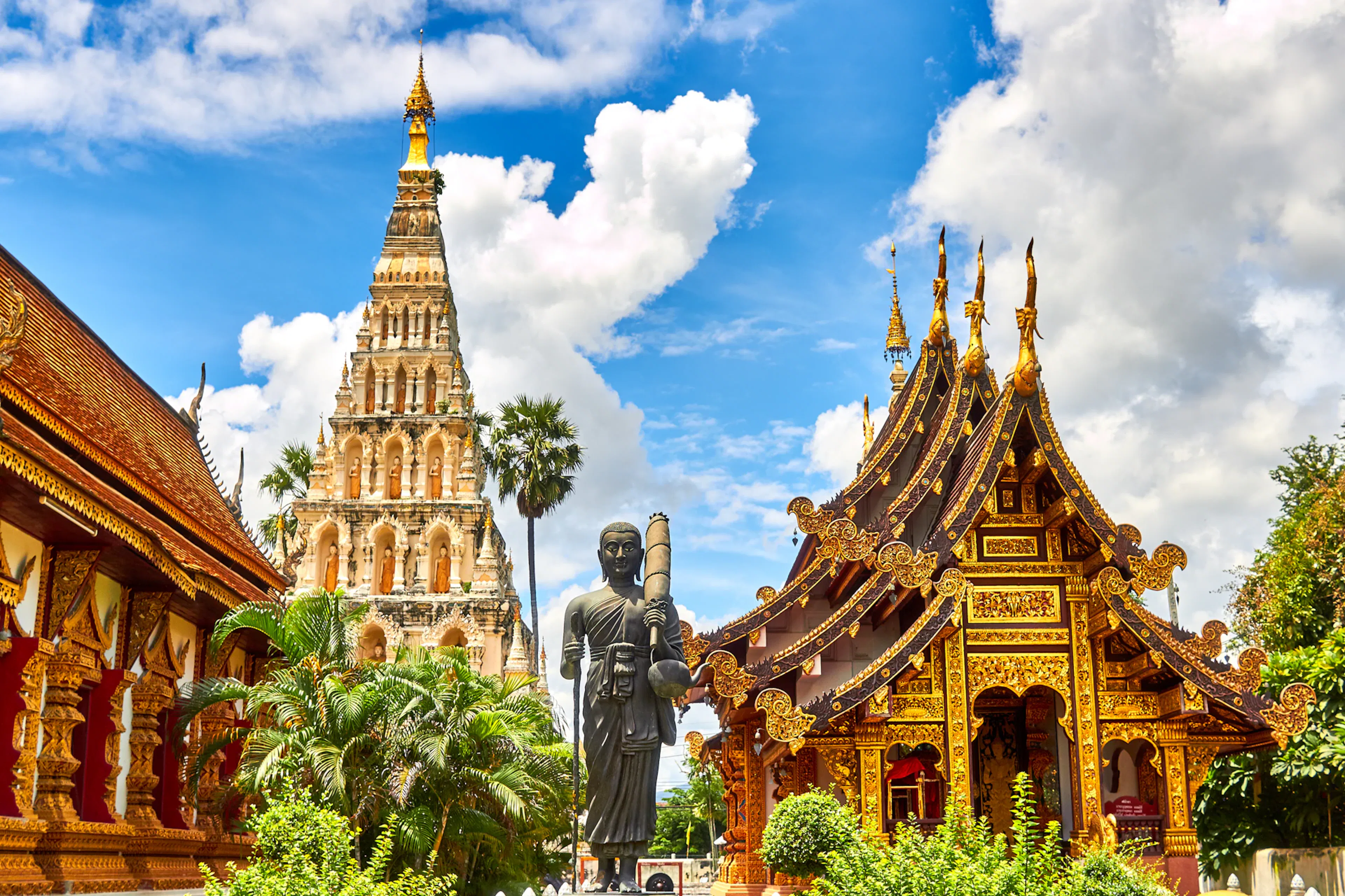 Thai temple surrounded by lush tropical greenery