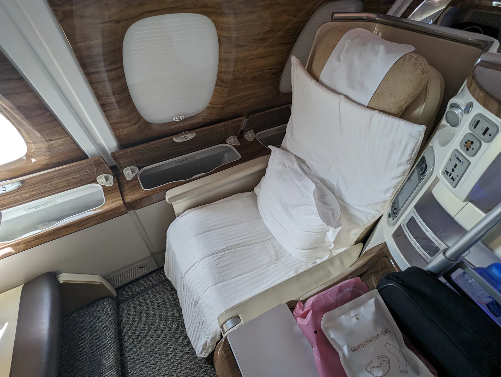First class suite with lie-flat bed and wood paneling