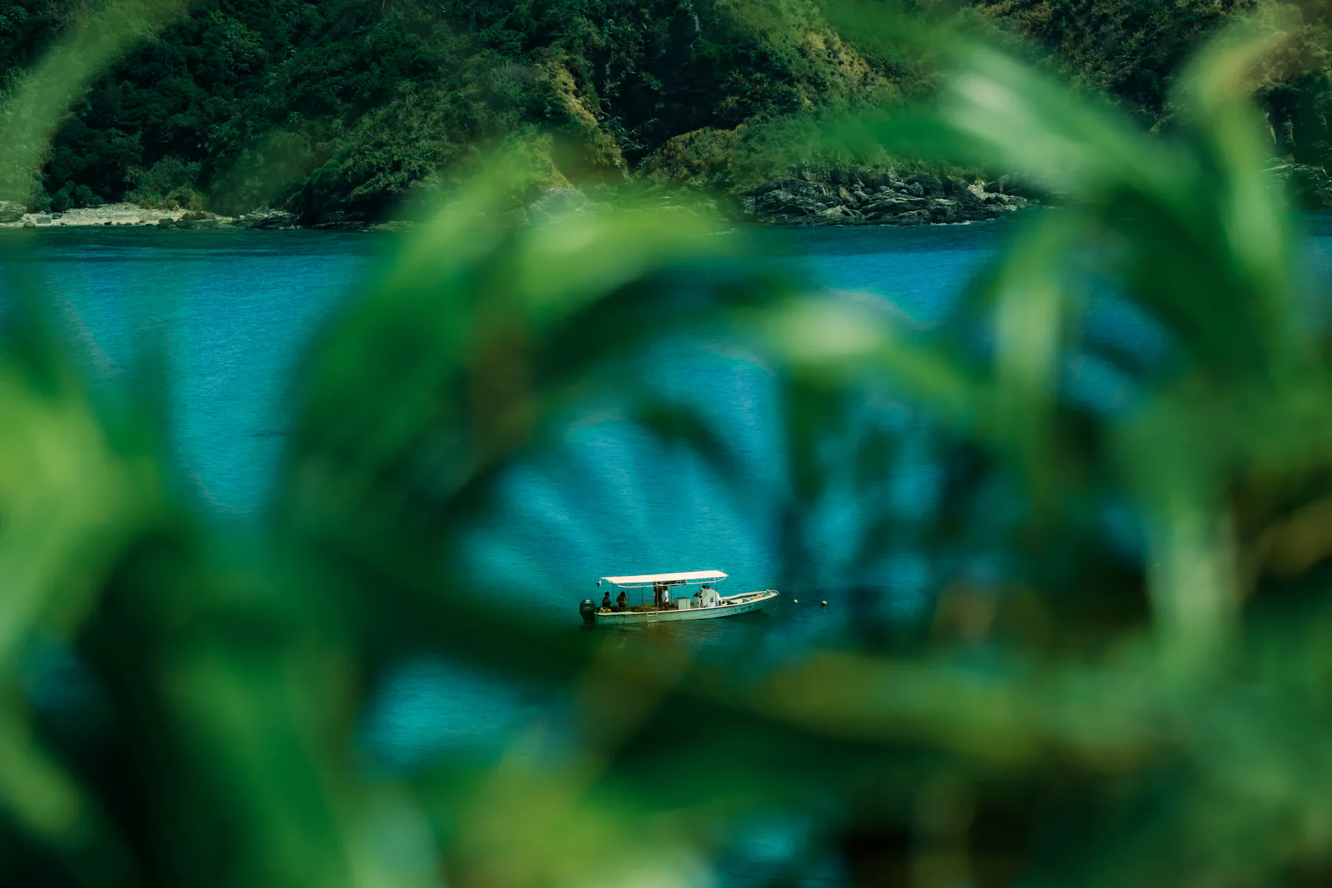 White boat on turquoise water in Okinawa