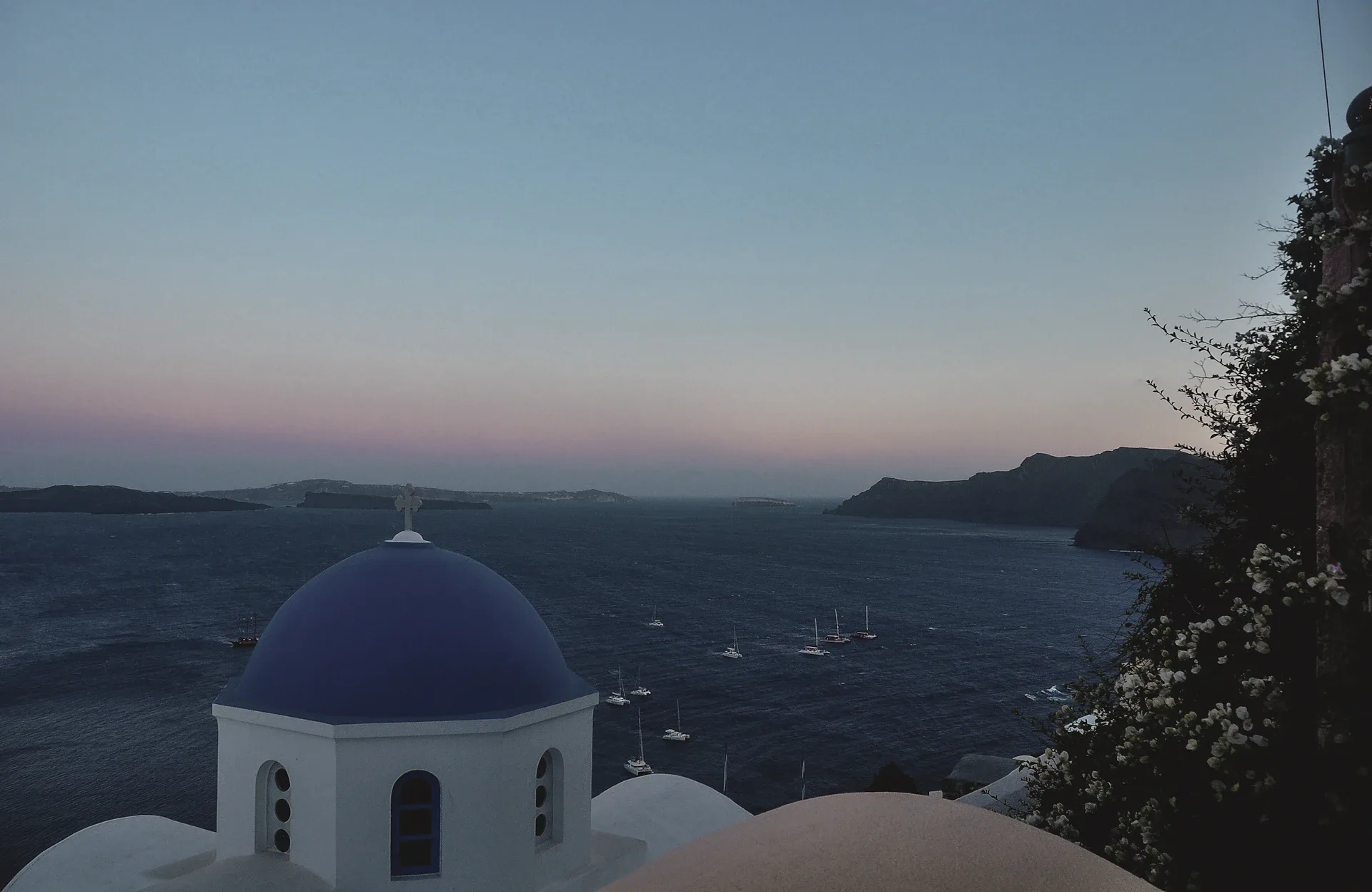 Santorini sunset with white and blue dome buildings
