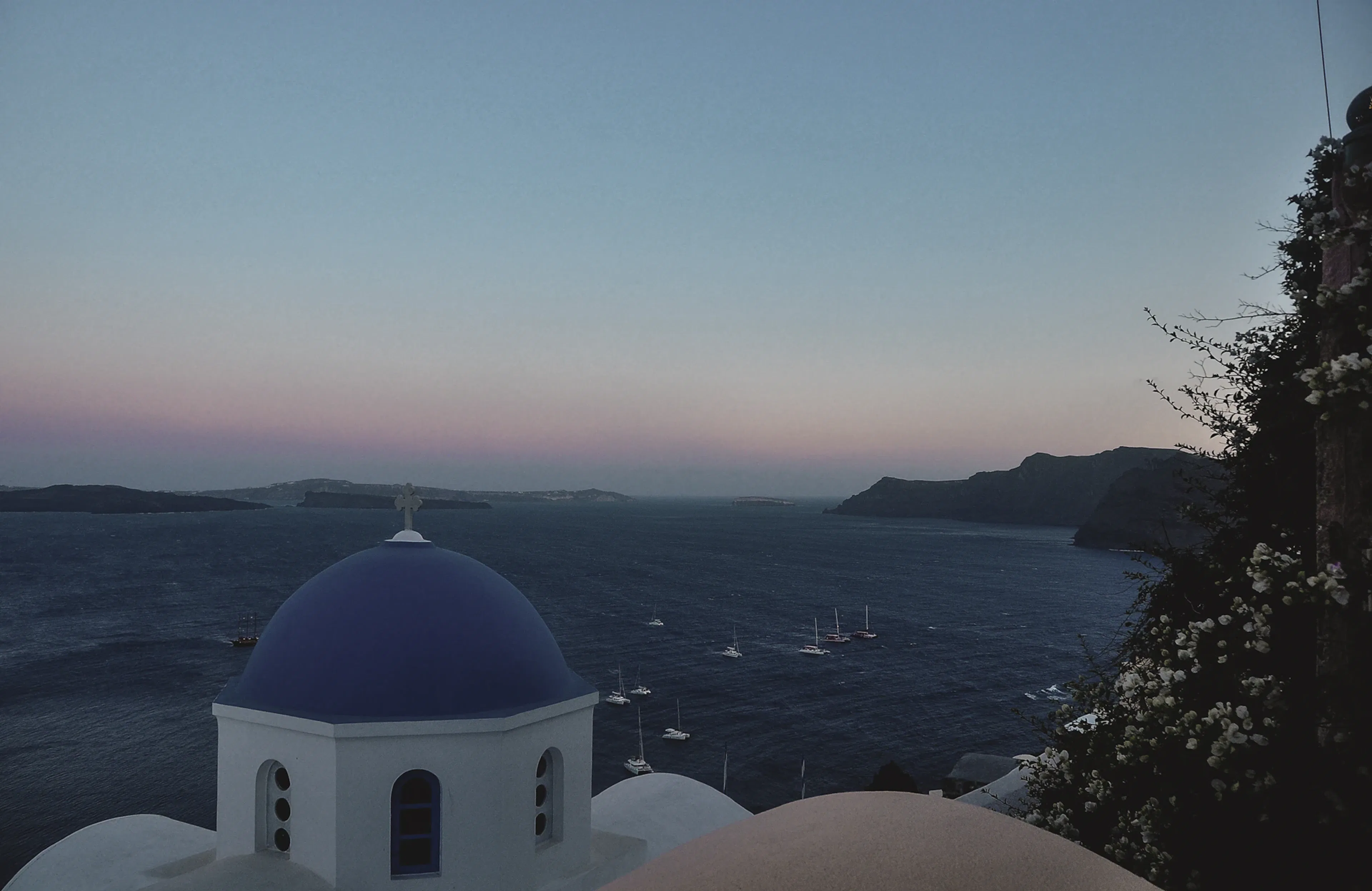 Santorini sunset with white and blue dome buildings